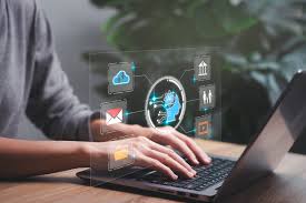 Person typing on a laptop with a translucent interface overlay displaying cloud, email, building, people, and video icons arranged around a head silhouette. A potted plant is visible in the blurred background.